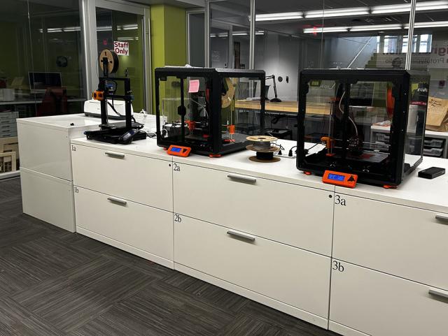 3d printers on top of a cabinet