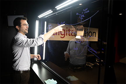 An instructor standing behind the lightboard with the lights shown